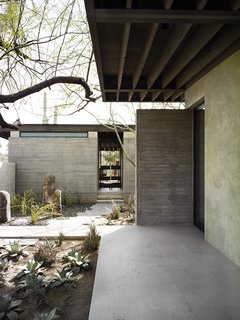 The Phoenix home of designers and builders Sarah Swartz Wessel and Ethan Wessel sits amid desert-friendly trees and plants. The couple bought the property in 1998 and worked on the house for a decade. 
