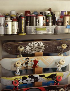 In the music room, skateboards are stored below spray paints the family and friends use to decorate the skate bowl.