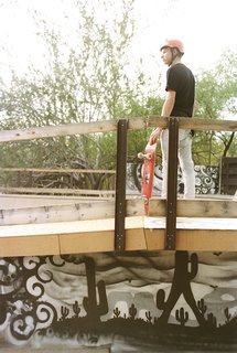 Addison stands on the deck of the bowl above graffiti art by Lalo Cota. 