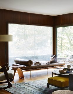 Bulldogs Sasha and Sophie rest on a Mies van der Rohe daybed in the lower den. The Capelli stool by Carol Catalano and the rocker by Adrian Pearsall are reserved for their owners. 