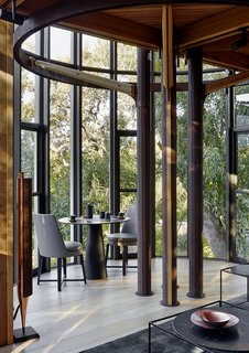 The tree house–inspired design mimics the surrounding woods. On each floor, steel rings and columns support Western red cedar floor joists above.