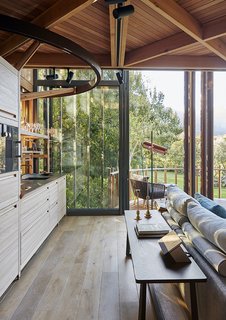 The kitchen features elm cabinets made by Valcucine in Italy.