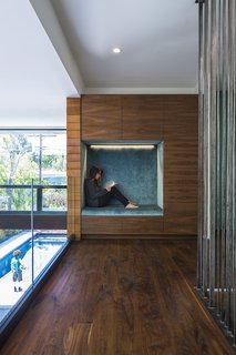 The second-floor niche, which is lined in Osborne & Little fabric, offers a quiet getaway. 