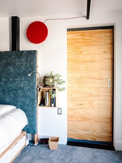 For his bedroom, Max designed a custom headboard insulated with several layers of cotton and upholstery fabric to reduce sound.