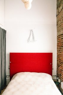 A bedroom next to the living area has an overhead lantern Max made by wrapping string soaked in glue, water, and corn starch around an inflated balloon, deflating it, and then lining it with rice paper-mache.