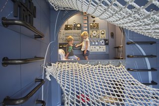 In the cockpit of their imaginary rocket ship, the kids tinker with a dashboard of dials, levers, and knobs assembled by artist Christophe Gauspohl.