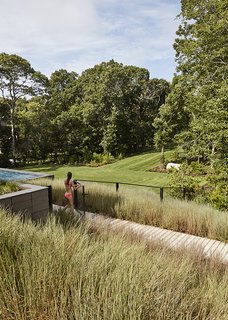 "I really wanted to explore the potential of the property, because the original house was probably using one-tenth of its capacity," says Masi, who also conceived the landscape and lighting design. He selected native grasses and other plantings for their ability to move with the wind. 