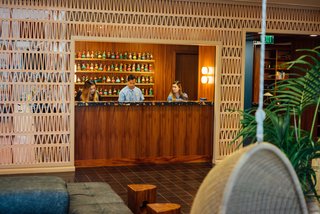 The welcoming, tropical lobby is located on the second floor, providing a place for guests to enter peacefully away from the hustle and bustle of the street. 