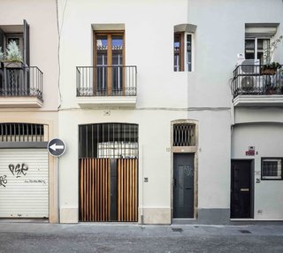Two formerly separate levels are linked and combined into a double-height volume in this 1,464-square-foot apartment in Barcelona, Spain.