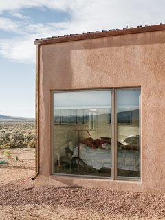 A Rookie Designer and Her Builder Father Create an Artist's Sculptural Loft in the Desert - Photo 5 of 10 - A gravel perimeter keeps mud from splashing on the walls when it rains. Adds Molly, "You can get away with minimal landscaping because there’s so much natural vegetation here." 