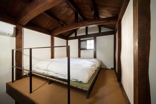 A Minimalist Townhouse Provides Serene Accommodations in Historic Kyoto - Photo 8 of 12 - The second floor bedroom is surrounded by clay walls. A tatami and futon provide sleeping quarters for two people; a mattress is available, too.