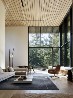 Nature Drove the Design of This Sculptural, Cor-Ten Steel House in Northern California - Photo 4 of 13 - The living room features a sectional sofa and leather chair by Zanotta, coffee tables by Porro, a Kymo rug, and a floor lamp from Flos. 