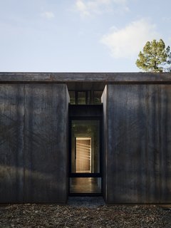 Nature Drove the Design of This Sculptural, Cor-Ten Steel House in Northern California - Photo 6 of 13 - Overlooking the double-height living/dining area is the mezzanine level, where the master suite and office are located. 