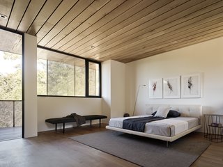 Nature Drove the Design of This Sculptural, Cor-Ten Steel House in Northern California - Photo 9 of 13 - A charcoal triptych by Gina Jacupke hangs above the Living Divani bed in the master suite.