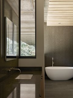 Nature Drove the Design of This Sculptural, Cor-Ten Steel House in Northern California - Photo 11 of 13 - In the master bathroom, a tub and sink from ADM join Cifial fixtures. 