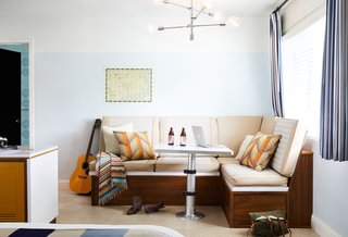 The rooms are reminiscent of midcentury motor lodges. The camper van-style bench here can be converted into a double bed.