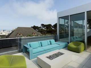 A Historic Victorian in San Francisco Is Meticulously Transformed Into a Modern Family Home - Photo 24 of 26 - Boasting sweeping downtown views, the roof deck reconciles complex geometry to accommodate a staircase, elevator, and usable social space. A fireplace is surrounded by outdoor seating designed by Paola Lenti.