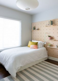 Feel at Home While Exploring Austin at One of These Modern Short-Term Rentals - Photo 3 of 17 - The second bedroom has a trundle twin bed and is finished with a quirky wooden wall treatment.