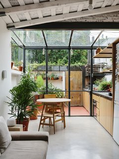 An Architect Turns His Small, Dark Apartment in Buenos Aires Into a Bright and Airy Home - Photo 1 of 10 - A steel and glass structure wraps one end of the apartment, adding the illusion of greater space to the 720-square-foot home.