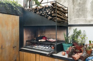 An Architect Turns His Small, Dark Apartment in Buenos Aires Into a Bright and Airy Home - Photo 4 of 10 - A sleek version of the traditional parrilla, or grill, handcrafted by Oficios Asociados, has pride of place on the patio counter.