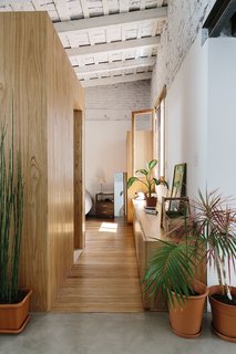 An Architect Turns His Small, Dark Apartment in Buenos Aires Into a Bright and Airy Home - Photo 6 of 10 - A box sheathed in the same material acts as a divider and holds the bathroom.