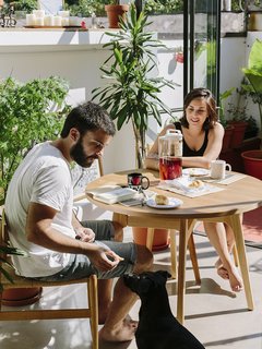 An Architect Turns His Small, Dark Apartment in Buenos Aires Into a Bright and Airy Home - Photo 7 of 10 - On warm days, when the glass wall is open, meals in the kitchen have an alfresco feel. The dining table is by Boulevard Furniture and the chairs are by Alejandro Sticotti for Net Muebles.