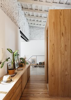 An Architect Turns His Small, Dark Apartment in Buenos Aires Into a Bright and Airy Home - Photo 9 of 10 - A wood floor uncovered during demolition delineates the private quarters.