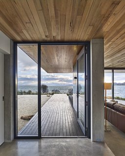 The dwelling’s concrete slab meets a New Zealand pine deck at the custom steel entrance door. Styled by Julia Landgren
