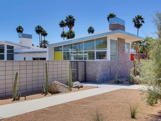 Inspired by the rebellious 1960s, the swinging 1970s, and Hollywood glamour, this colorful, two-bedroom, two-bathroom condominium unit gives guests access to a shared pool, fire pit, and outdoor BBQ area. 