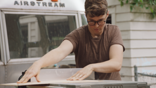 Ellen Prasse works with a table saw outside the Airstream she and Oliver are renovating.