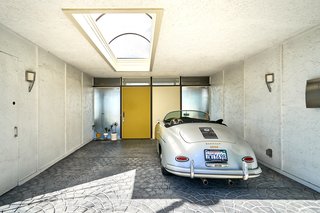A Midcentury-Modern Home in L.A. Designed by Richard Banta Is For Sale For $899K - Photo 13 of 13 - A skylit carport is finished with original hardware, graphic paving, and a painted door.