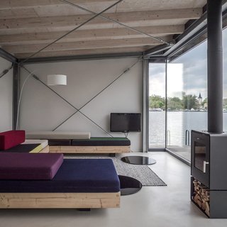50 Modern Homes With Floor-to-Ceiling Windows - Photo 24 of 50 - Removed from the urban bustle—though just 15 minutes from the center of the city—the Modern Houseboat offers a unique opportunity to experience a life on water, while taking in the beautiful natural surroundings that this part of the city has to offer. 