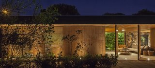 An Incredible Brazilian Home That Celebrates Art, Travel, and Nature - Photo 1 of 14 - In addition to adding visual intrigue, the slatted-wood facade is quite functional. It screens direct sunlight in order to create a cooler, more pleasant indoor environment.
