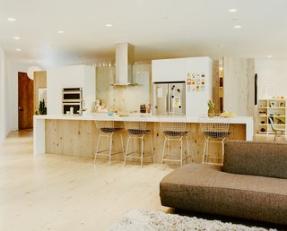 In the kitchen, Structube stools pull up to a Quartzforms countertop. 