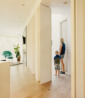 Maple columns painted Benjamin Moore Ultra White mirror the steel pillars found outside.