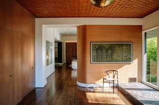A curved zebrawood wall greets visitors in the foyer. 