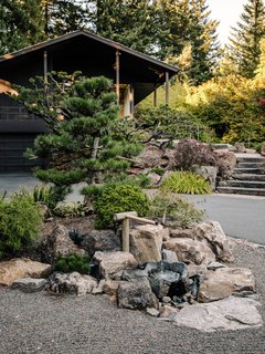 A Japanese-style bamboo fountain sits in the driveway.
