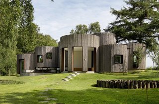 Stay in This Danish Vacation Home Made Up of 9 Log-Clad Cylinders - Photo 1 of 14 -