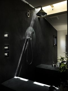 In the bathroom behind the closet, Samantha embedded charcoal in the stucco for a velvety texture. Skylights by Velux introduce patterns throughout the day. "I wanted to focus the light in very precise ways," says Samantha.