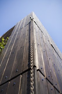 Galvanized rain chains transport water off the roof. "Depending on how the exterior catches the light, it can appear almost metallic, or you can see the depth of the wood grain," says Samantha.