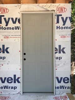 Waldman and team got the cheapest door they could find at Home Depot. It was a particularly thin metal gauge they were clearing out. There were other used options at the rebuilding center for even less, but having never done this before they opted for the presumed ease of a pre-hung, new door. 