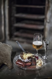 We were treated to a traditional dinner of hyttsill at Kosta Boda—the food is prepared in the furnaces where glass has been left to cool down. Above, we're having "hot shop" herring, smoked sausage, fried pork, baked potato, and lingonberry jam.