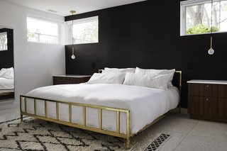Midcentury Mashup: A 1950s Ranch House in Chicago Gets a Palm Springs-Style Butterfly Roof - Photo 11 of 15 - An Alchemy bed from CB2 is flanked by marble-topped night stands. The Krisztian Mecs for Intueri Light pendants are from Lumens. 