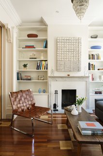 The parlor’s mixed-wood floor includes cherry with maple parquet. The Pol chair is by Mark Albrecht Studio. 