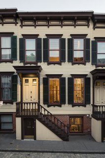 All 20 row houses on Sylvan Terrace have matching yellow, brown, and green facades, as dictated by the Landmarks Preservation Commission. The architectural style was inspired by the nearby Morris-Jumel mansion, built in 1765. 