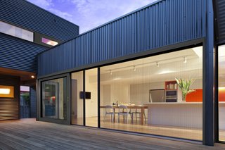 8 Things to Consider When Choosing Retractable Glass Walls - Photo 11 of 15 - Retractable screening can provide protection from insects while affording privacy.