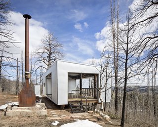 The steel firebox situated on the central axis is a ruin from the fire and functions as a centerpiece for outdoor space. "It's kind of a beautiful marker for the site—quite a dramatic contrast with shiny abstract," says Logan.