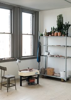 In one corner of the studio, Spellman has an area dedicated to ceramics, as pictured above.