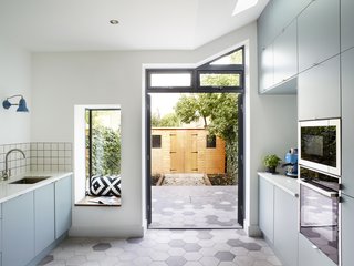 The appliances are by Neff and the wall lamp is by Anglepoise. In the backyard, the couple installed a shed for storing their bicycles. The window seat was an item on Emma’s wish list.