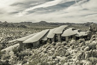The Desert House is about 40 miles outside of Palm Springs, sited on a pile of boulders at the edge of Joshua Tree National Park, and it was finished in the early 2000s, long after the heyday of post-and-beam modernism. Yet there may not be another residence more attuned to the hardened landscape of the Coachella Valley than Kendrick Bangs Kellogg’s most outré experiment in organic architecture. 